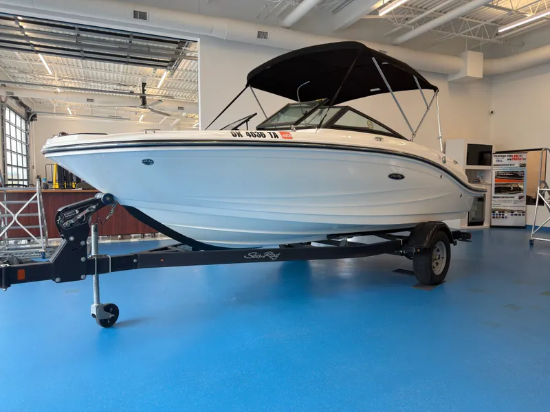 The Image of 2018 Sea Ray 190 boat displayed in a showroom. - 1