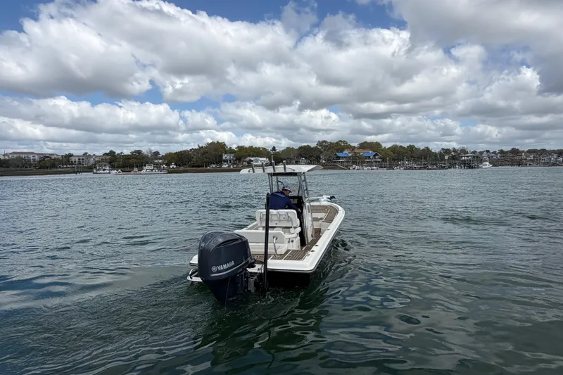 Slide: The Image of 2013 ShearWater 25 LTZ boat on water with Yamaha engine, cloudy sky background. - 11