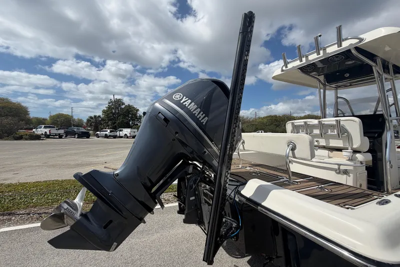 Slide: The Image of 2013 ShearWater 25 LTZ boat with Yamaha outboard motor, parked under a cloudy sky. - 25