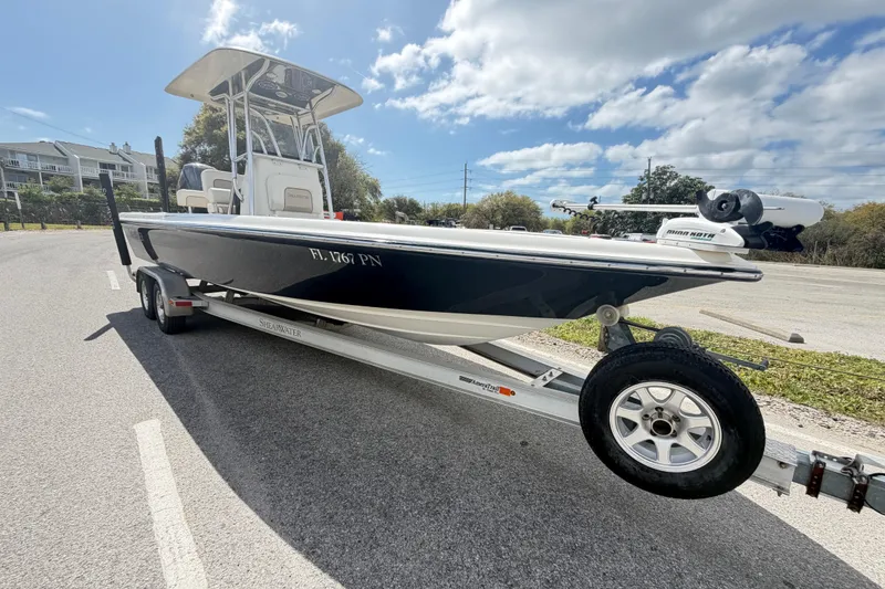 Slide: The Image of 2013 ShearWater 25 LTZ boat on trailer under blue sky. - 26