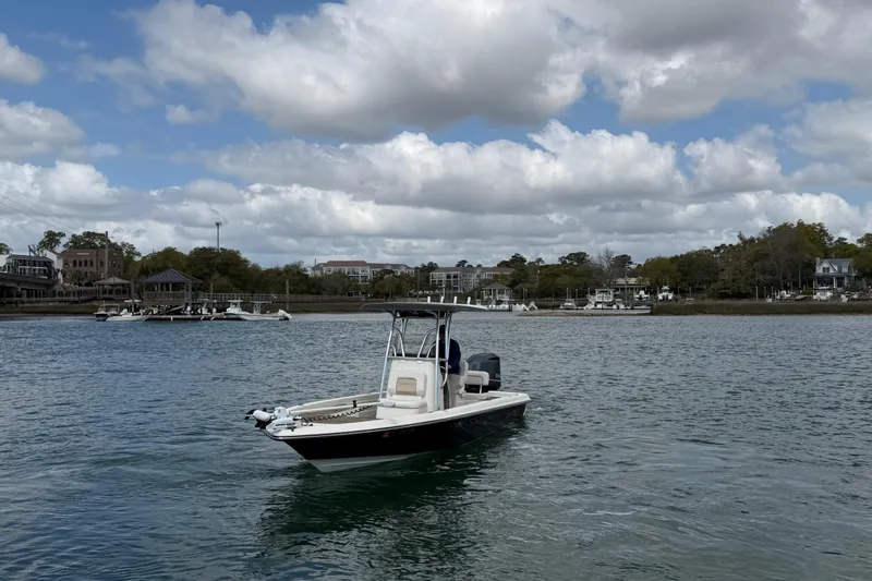 Slide: The Image of 2013 ShearWater 25 LTZ boat on calm water under cloudy sky. - 3