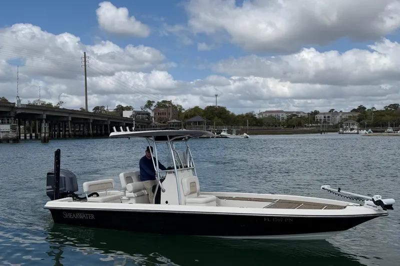 Slide: The Image of 2013 ShearWater 25 LTZ boat on calm water under cloudy sky. - 7