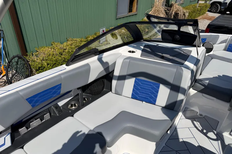 Slide: The Image of 2022 Malibu Wakesetter 25 LSV boat interior with gray and blue seating. - 14