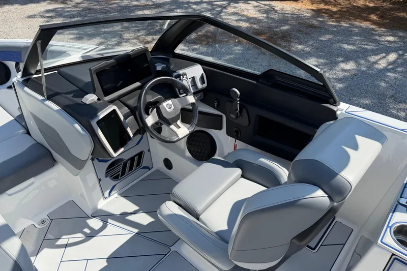 Slide: The Image of Interior of 2022 Malibu Wakesetter 25 LSV boat with modern dashboard and steering wheel. - 15