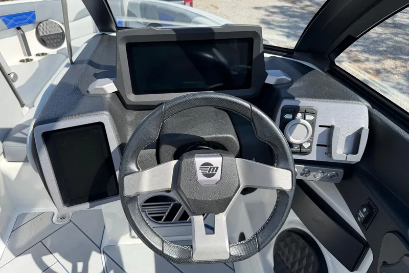Slide: The Image of 2022 Malibu Wakesetter 25 LSV dashboard with modern steering wheel and digital displays. - 16