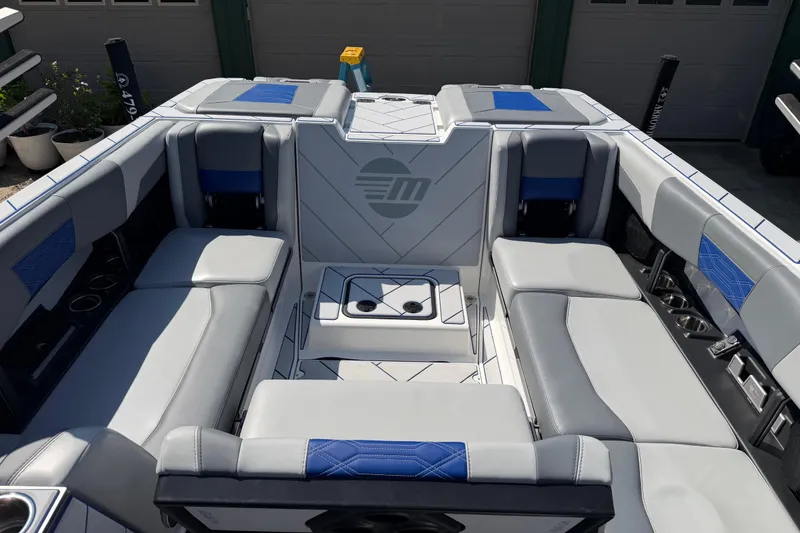 Slide: The Image of 2022 Malibu Wakesetter 25 LSV boat interior with gray and blue seating. - 17