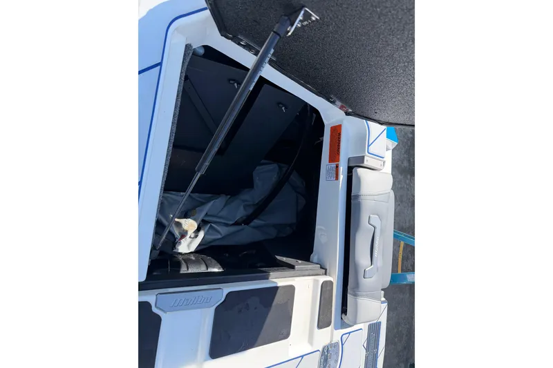 Slide: The Image of Open storage compartment of 2022 Malibu Wakesetter 25 LSV boat. - 19
