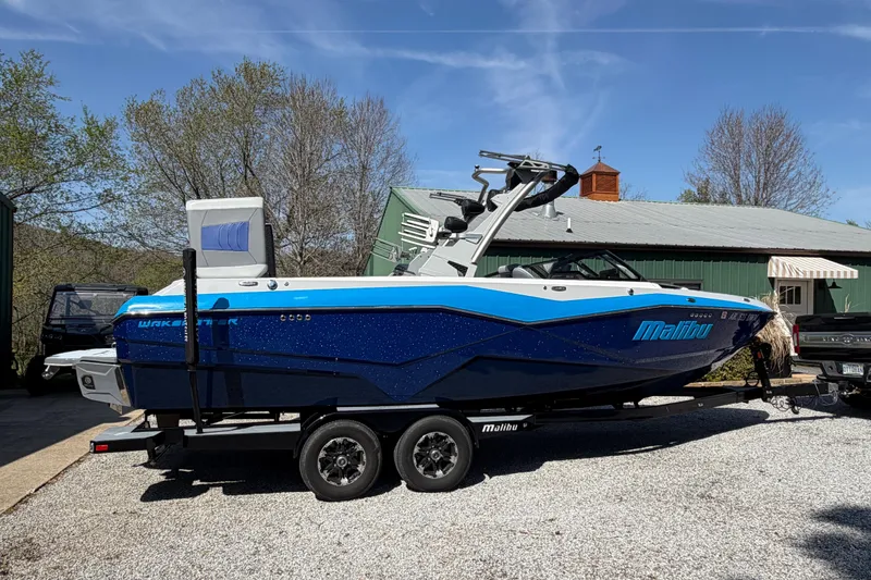 Slide: The Image of 2022 Malibu Wakesetter 25 LSV boat on trailer, parked outdoors. - 5