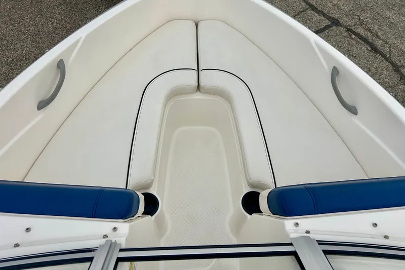 Slide: The Image of 2016 Bayliner 175 Bowrider boat interior with white and blue seating. - 11