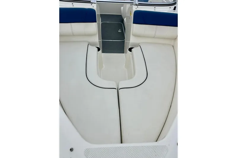 Slide: The Image of 2016 Bayliner 175 Bowrider interior with white seating and blue accents. - 16
