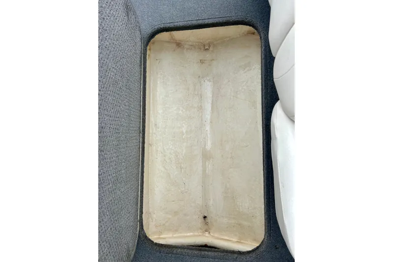 Slide: The Image of Storage compartment of a 2016 Bayliner 175 Bowrider boat, featuring a clean interior. - 21