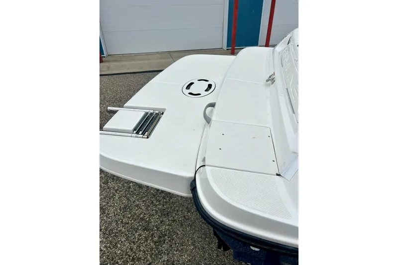 Slide: The Image of 2016 Bayliner 175 Bowrider swim platform with ladder, docked on concrete surface. - 34