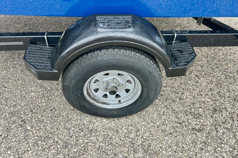 Slide: The Image of Trailer wheel of a 2016 Bayliner 175 Bowrider on asphalt surface. - 36