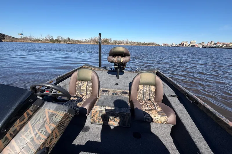 Slide: The Image of 2019 Ranger RT188P Fishing boat on a calm lake under clear blue skies. - 11