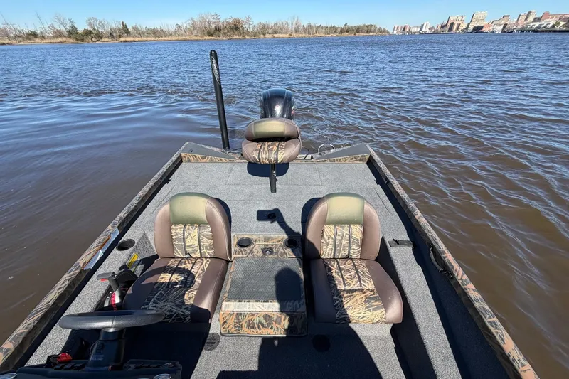 Slide: The Image of 2019 Ranger RT188P Fishing boat on calm water, featuring camo-patterned seats. - 12
