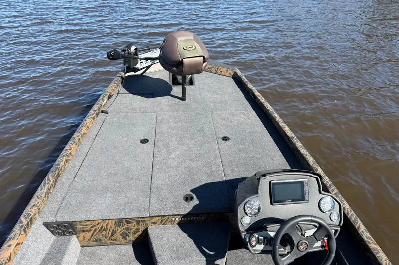 Slide: The Image of 2019 Ranger RT188P Fishing boat on water, featuring steering console and trolling motor. - 13