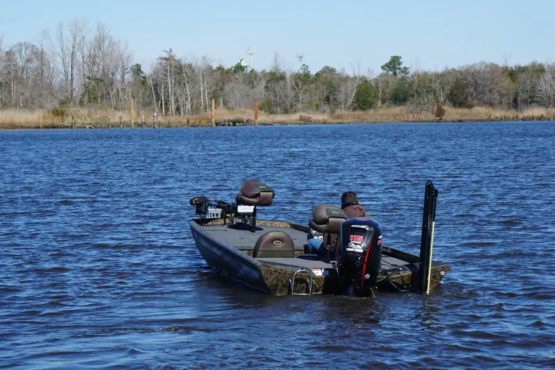 Slide: The Image of 2019 Ranger RT188P Fishing boat on a serene lake with trees in the background. - 3