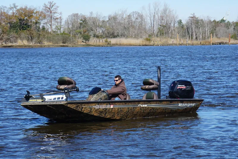 Slide: The Image of 2019 Ranger RT188P Fishing boat on a lake with a person driving. - 4