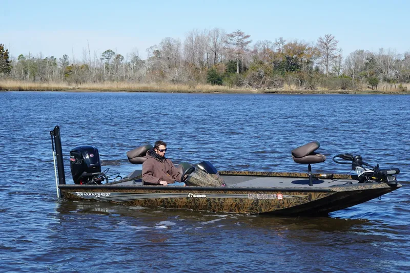 Slide: The Image of 2019 Ranger RT188P Fishing boat on a calm lake with a person onboard. - 7