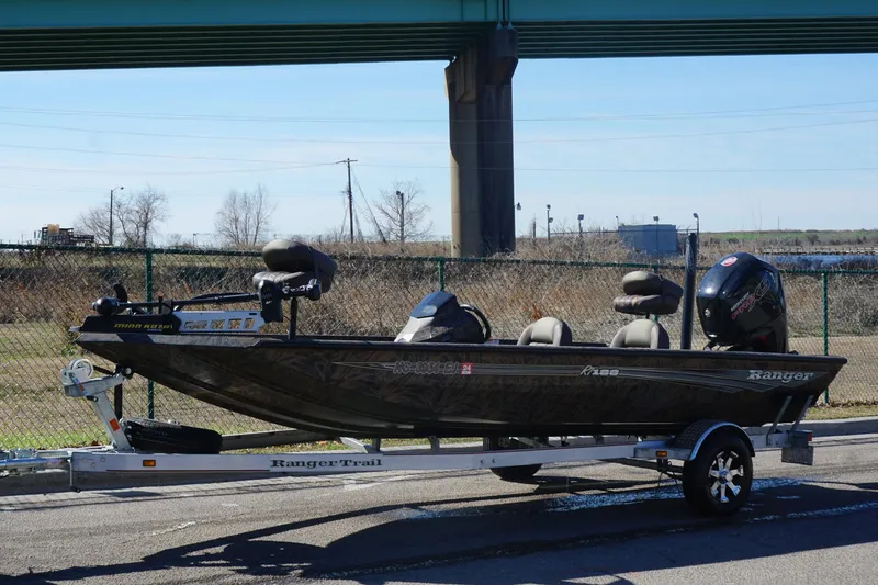 Slide: The Image of 2019 Ranger RT188P Fishing boat on trailer, parked outdoors under a bridge. - 9