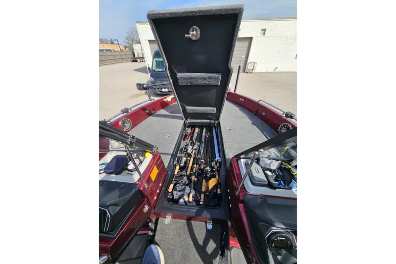 Slide: The Image of 2023 Skeeter WX2200 boat with open storage compartment filled with fishing rods. - 14