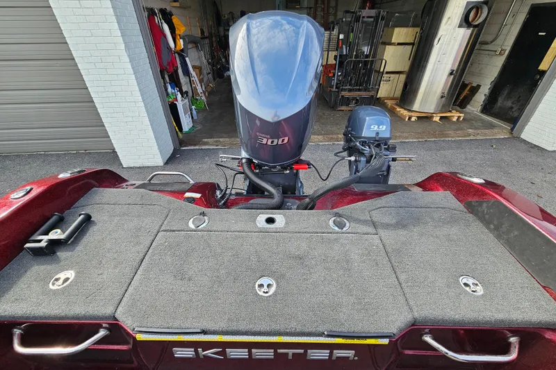 Slide: The Image of 2023 Skeeter WX2200 boat with dual outboard motors in a garage setting. - 17