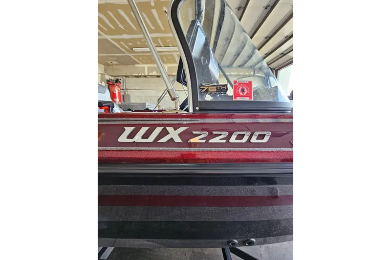 Slide: The Image of 2023 Skeeter WX2200 boat in garage, showcasing model name and windshield. - 2