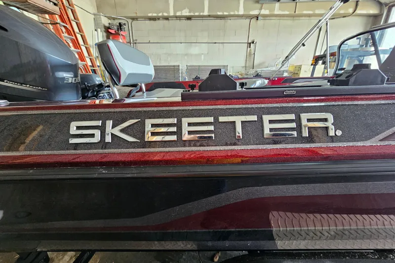 Slide: The Image of 2023 Skeeter WX2200 boat in a garage, featuring sleek design and Yamaha engine. - 4