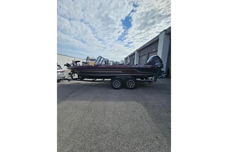 Slide: The Image of 2023 Skeeter WX2200 boat on trailer under cloudy sky. - 7