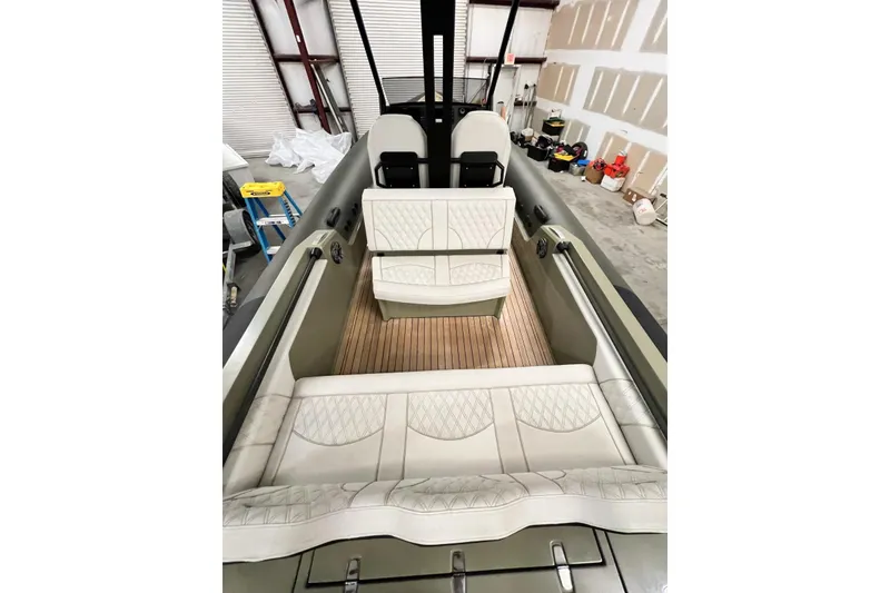 Slide: The Image of 2022 Technohull T9 boat interior with luxurious seating and wooden flooring. - 13