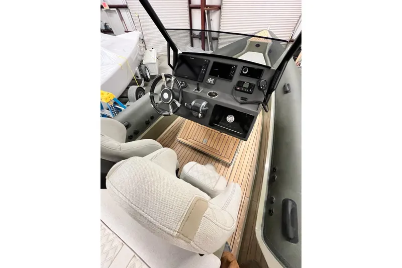 Slide: The Image of Interior view of 2022 Technohull T9 boat with modern dashboard and seating. - 16
