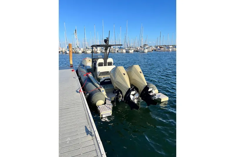 Slide: The Image of 2022 Technohull T9 boat docked with twin outboard engines in a marina. - 18