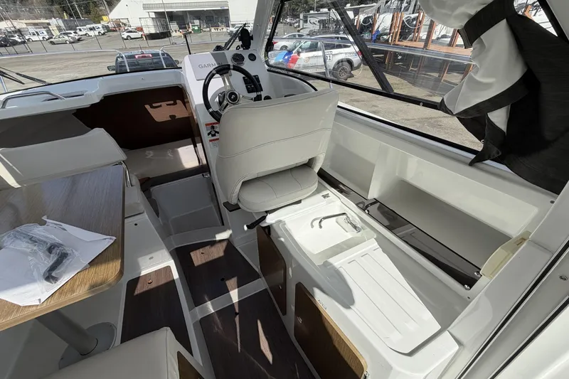 Slide: The Image of Interior of 2020 Beneteau Antares 7 boat, featuring helm and seating area. - 11