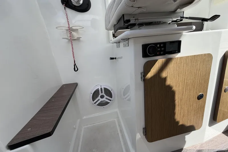 Slide: The Image of Interior of 2020 Beneteau Antares 7 boat with seating, storage, and audio system. - 12