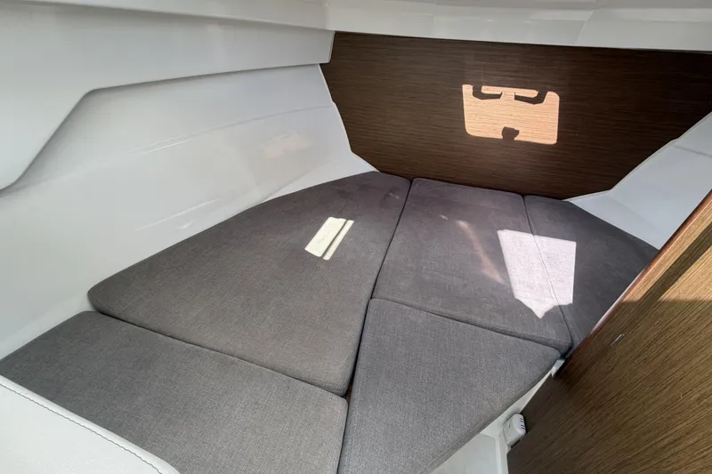 Slide: The Image of Interior cabin of 2020 Beneteau Antares 7 with cushioned seating and wooden accents. - 15