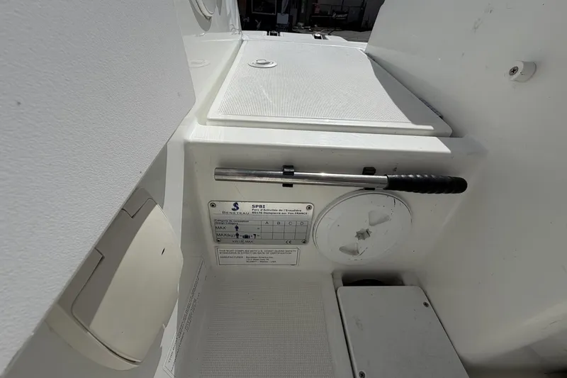 Slide: The Image of Interior view of a 2020 Beneteau Antares 7 boat, featuring control panel and storage. - 19