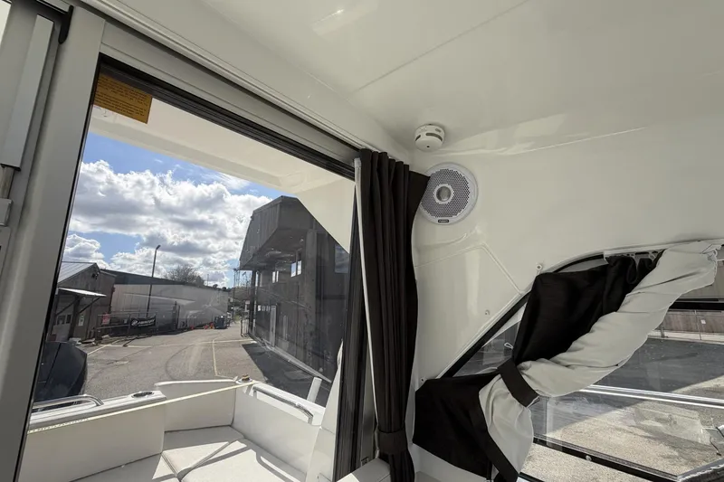 Slide: The Image of Interior view of 2020 Beneteau Antares 7 boat with windows and curtains. - 20