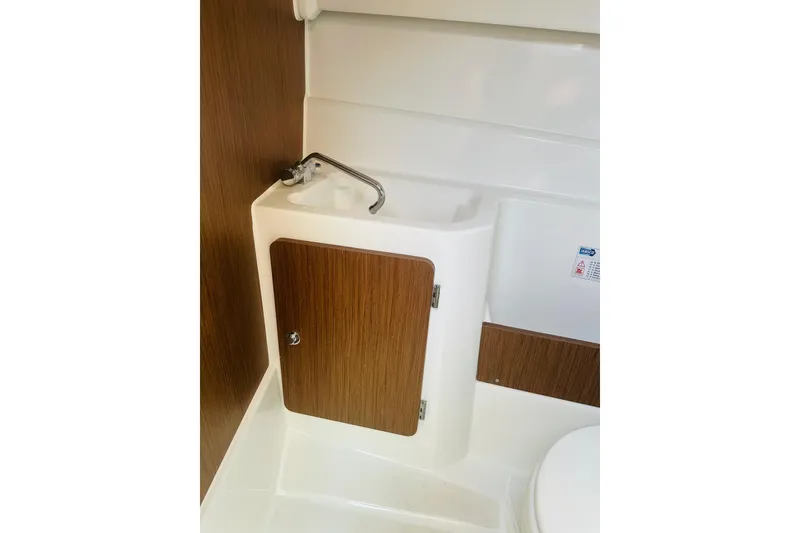 Slide: The Image of Compact bathroom sink in 2020 Beneteau Antares 7 boat, featuring wood accents and modern design. - 21