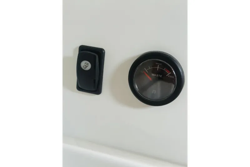 Slide: The Image of Control panel of 2020 Beneteau Antares 7 with waste level gauge and switch. - 22