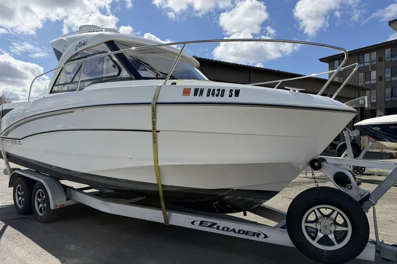 Slide: The Image of 2020 Beneteau Antares 7 boat on EZ Loader trailer under a cloudy sky. - 3