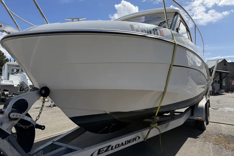Slide: The Image of 2020 Beneteau Antares 7 boat on trailer under clear blue sky. - 4