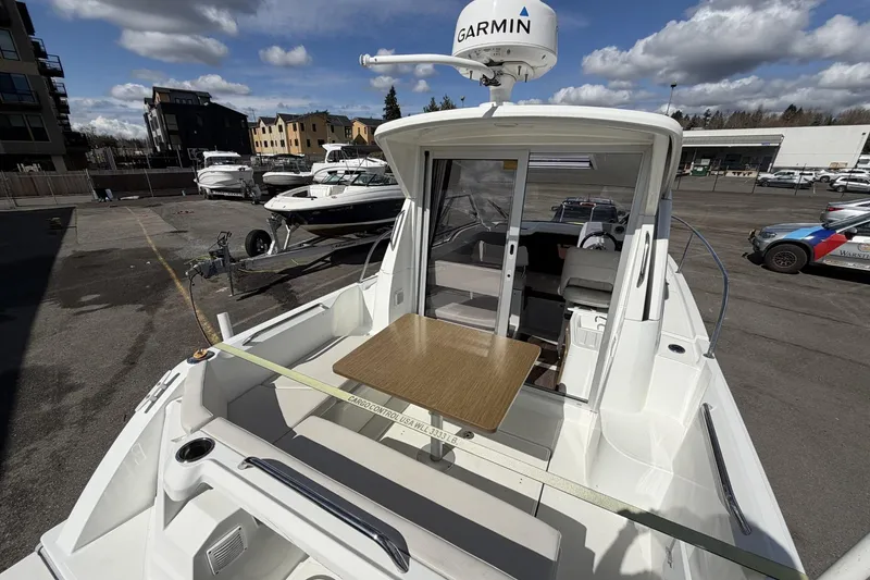 Slide: The Image of 2020 Beneteau Antares 7 boat with Garmin radar, docked outdoors under cloudy sky. - 8