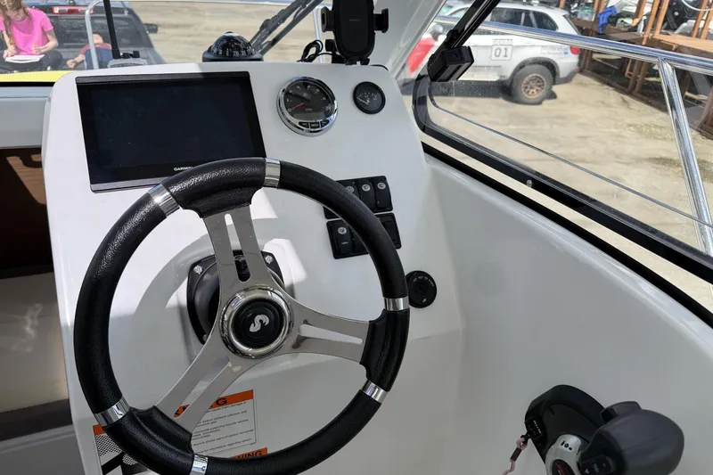 Slide: The Image of Cockpit of 2020 Beneteau Antares 7 with steering wheel and navigation controls. - 9