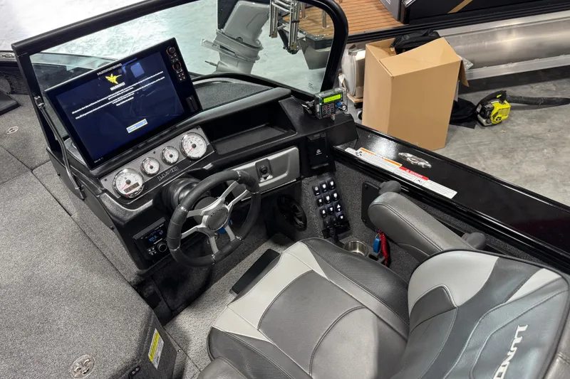 Slide: The Image of 2024 Lund 2075 Pro-V boat cockpit with steering wheel, digital display, and control panel. - 10