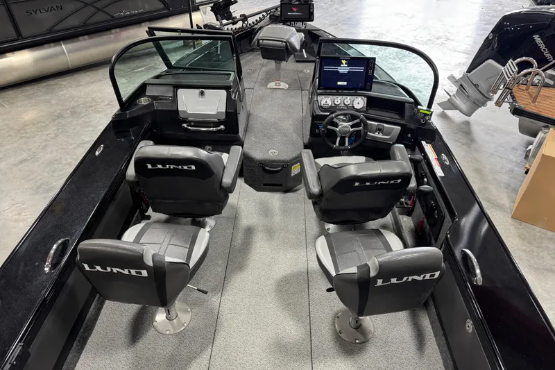 Slide: The Image of 2024 Lund 2075 Pro-V boat interior with dual seats and modern dashboard. - 11