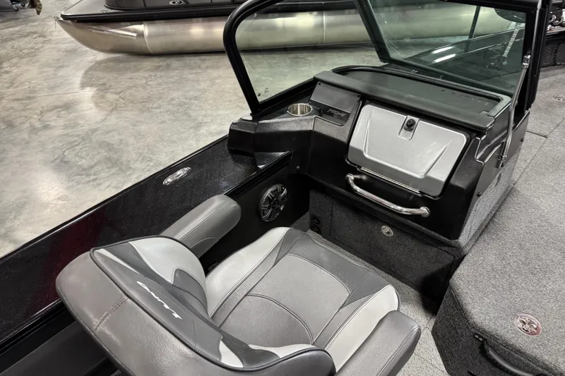 Slide: The Image of 2024 Lund 2075 Pro-V boat interior with gray seating and console details. - 14