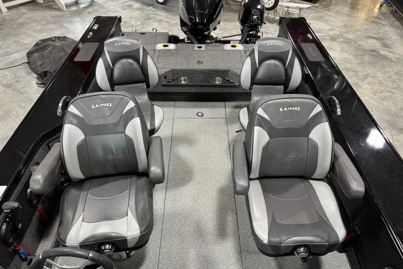 Slide: The Image of 2024 Lund 2075 Pro-V boat interior with four gray and black seats in a spacious layout. - 7