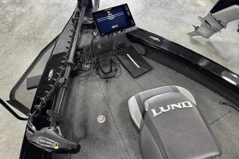 Slide: The Image of 2024 Lund 2075 Pro-V boat interior with advanced navigation equipment and branded seating. - 8