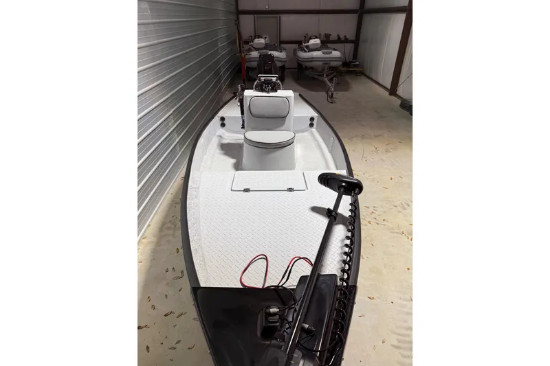 Slide: The Image of 2026 Santee 160 Center Console boat in storage, featuring a sleek design and modern equipment. - 3