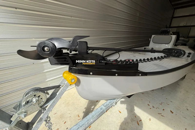 Slide: The Image of 2026 Santee 160 Center Console boat with Minn Kota PowerDrive motor in a garage. - 4